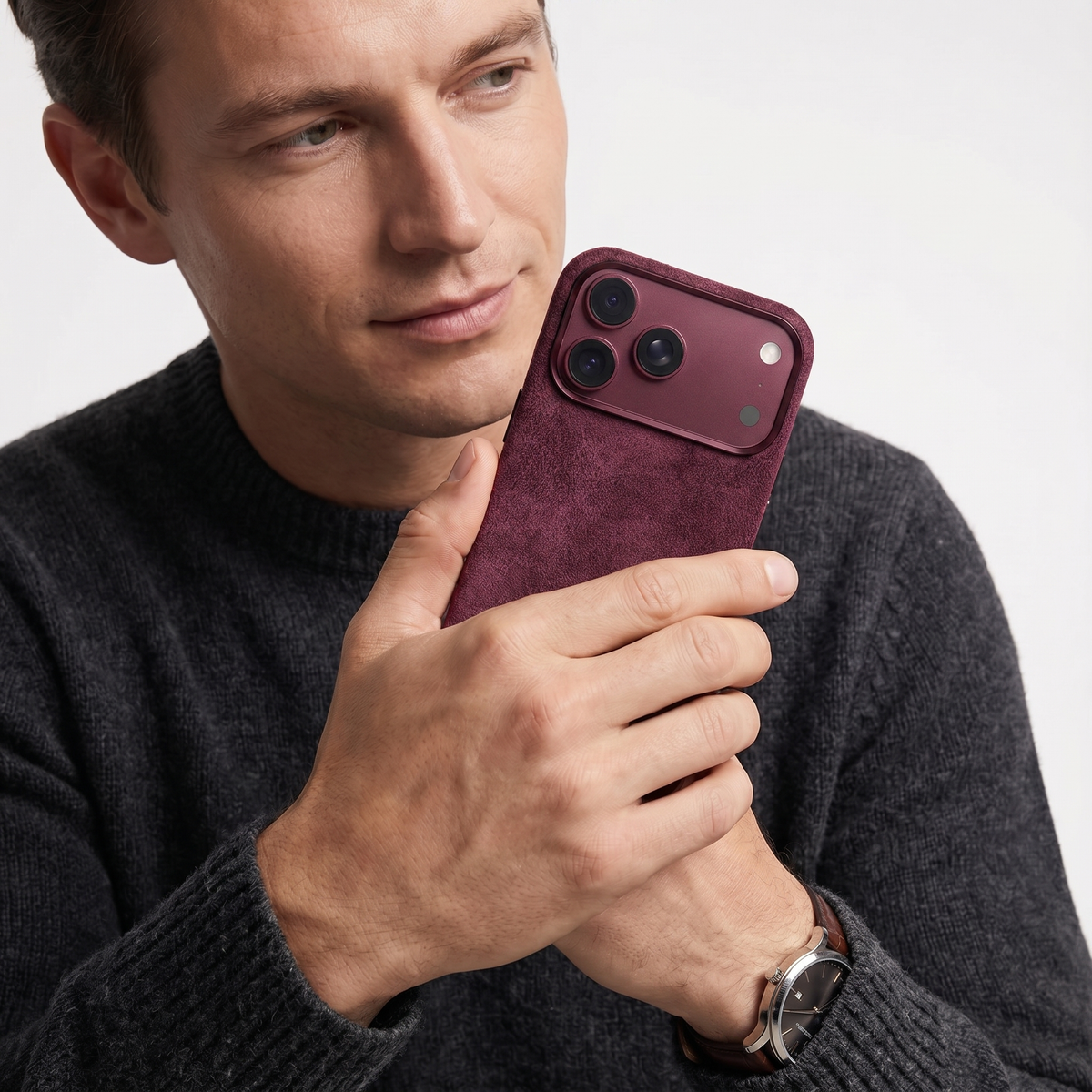 Wine Red Alcantara case for iPhone 18 Pro held in hands